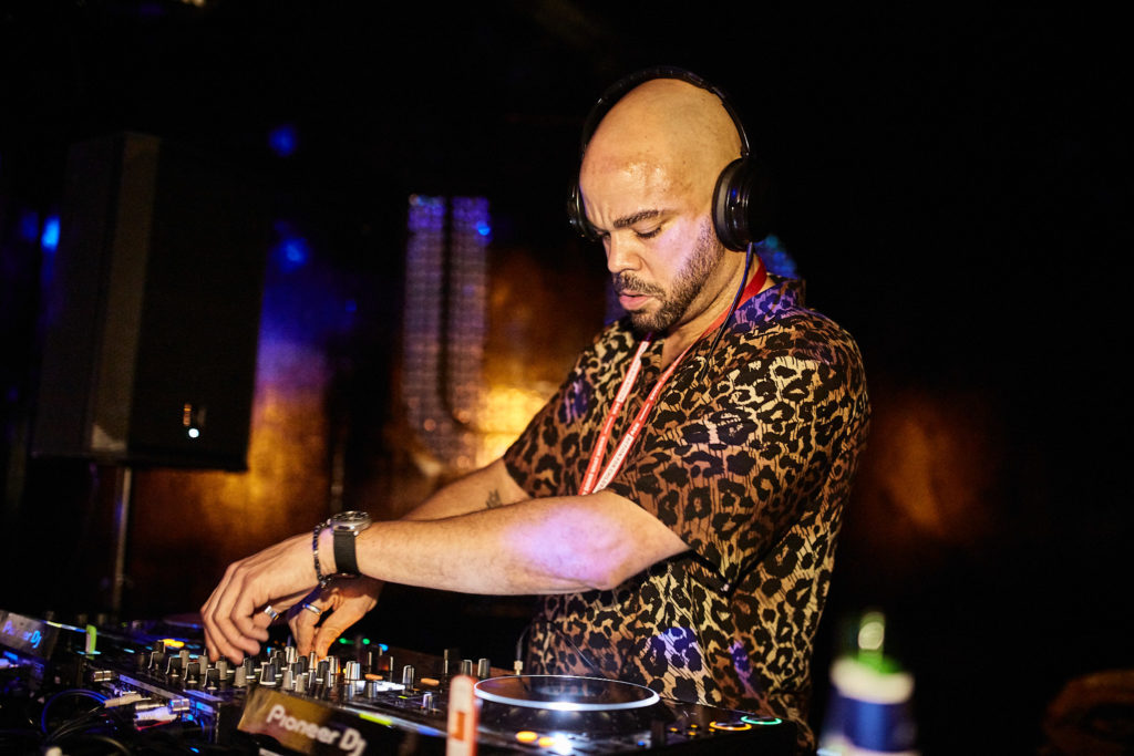 DJ in headphones mixing on the decks