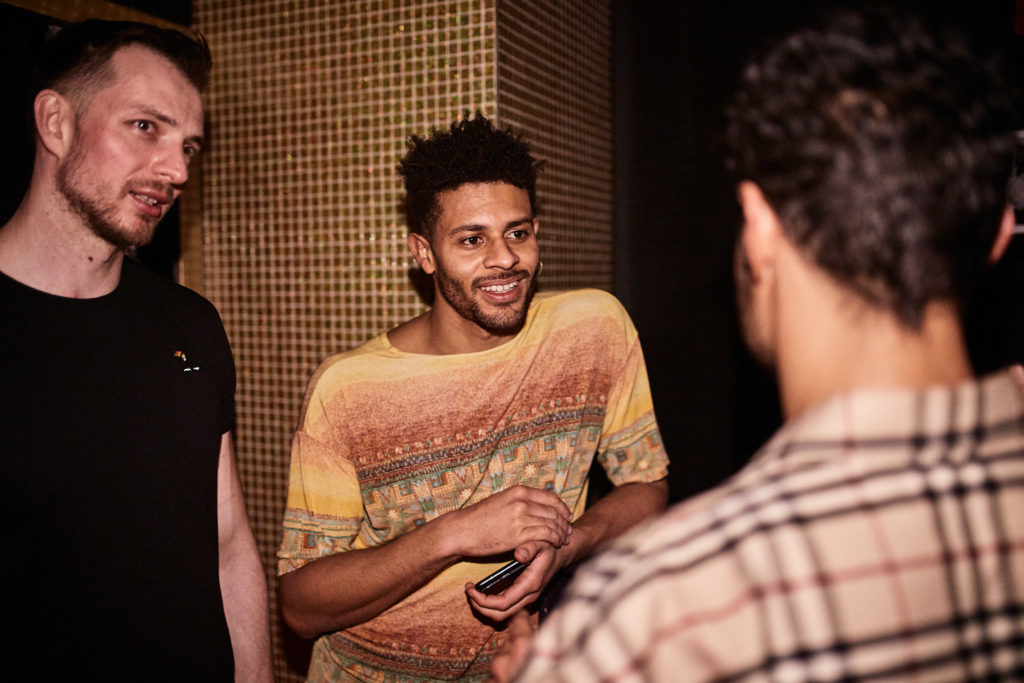Three friends chatting at the charity club night
