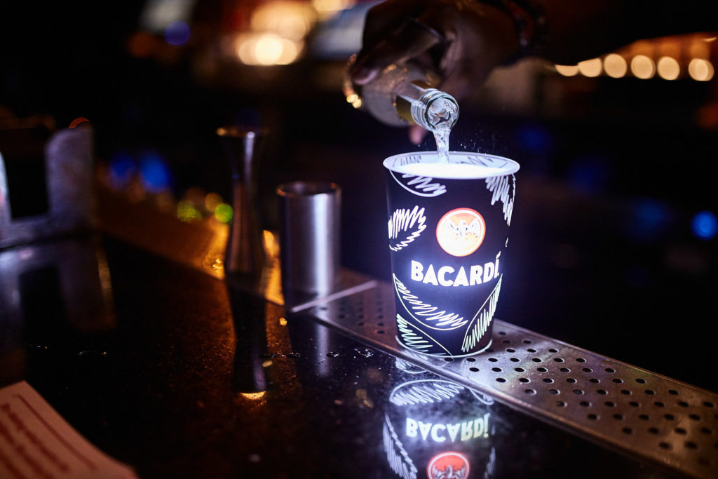 Bartender pouring a drink behind the bar