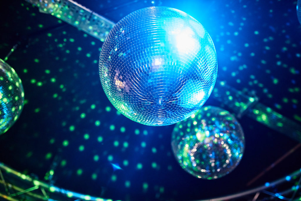 Mirror balls under blue lights at The Curtain Club