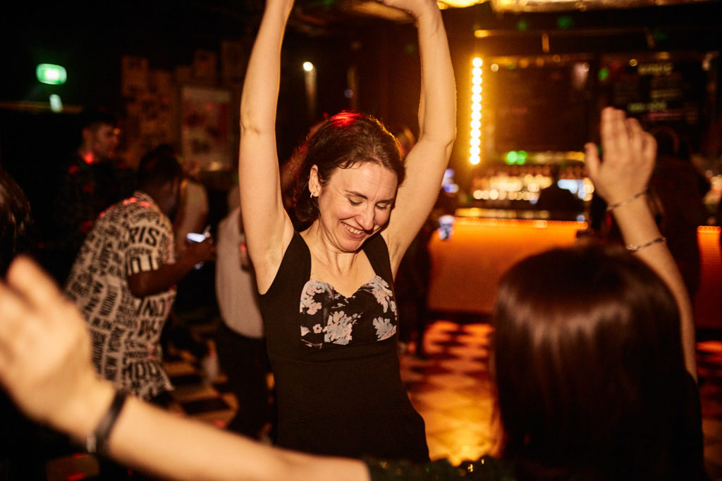 Guest dancing with her arms in the air