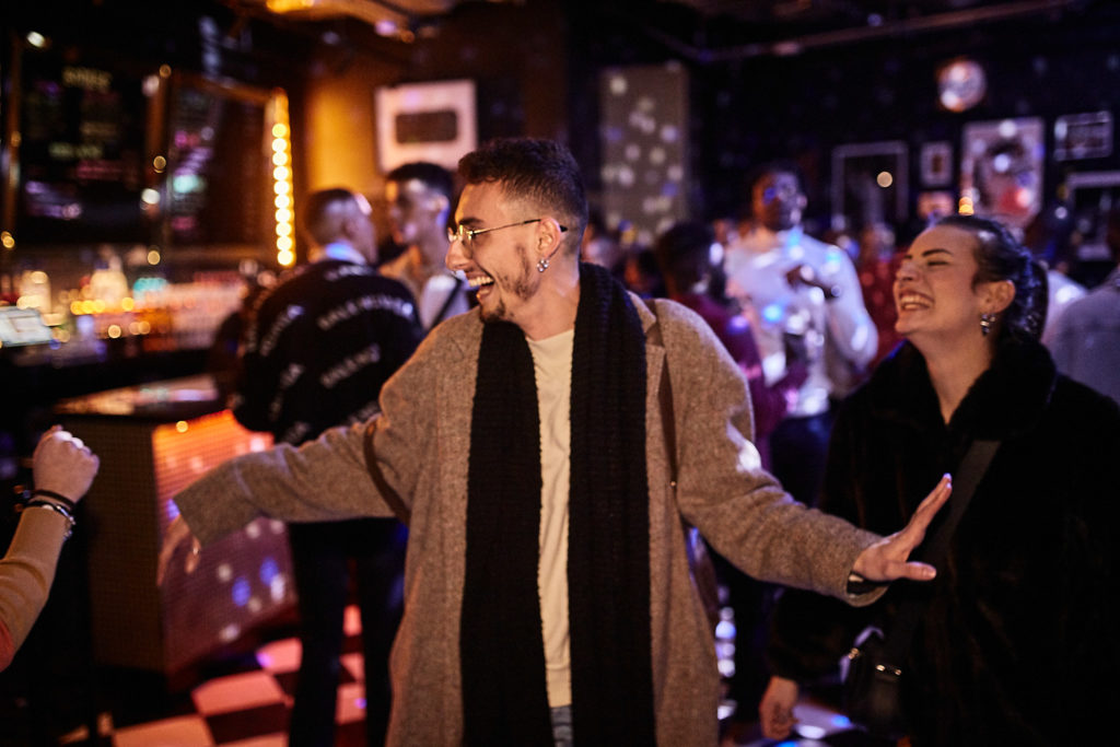 Guest dancing with his arms out on the dance floor