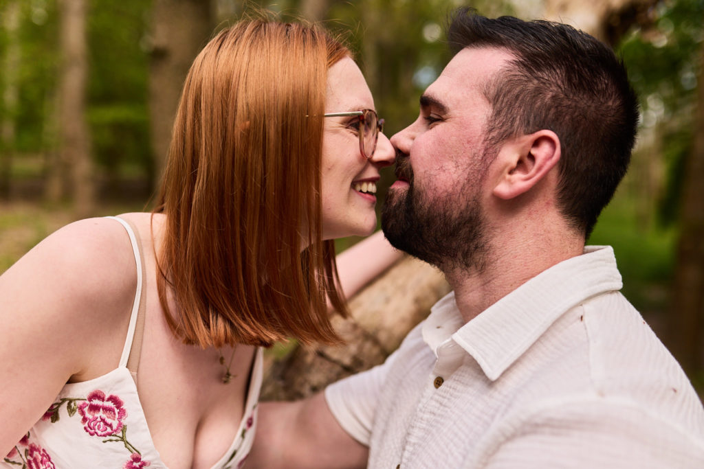 Close-up of an engaged couple laughing nose to nose