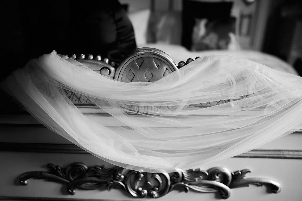 Black and white photo of the veil draped over ornate furniture