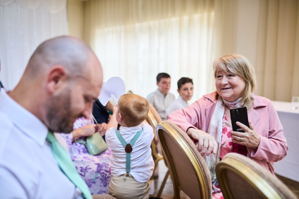 Wedding guests with a toddler waiting for the ceremony to start