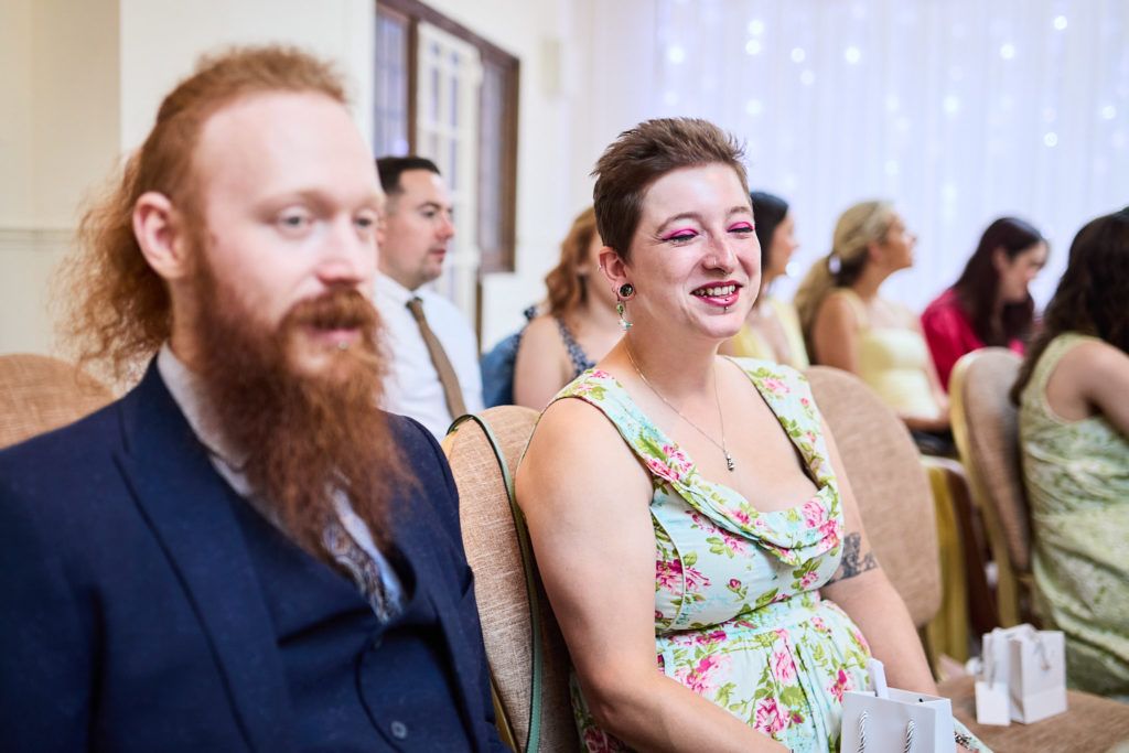 Wedding guests smiling as they wait for the ceremony
