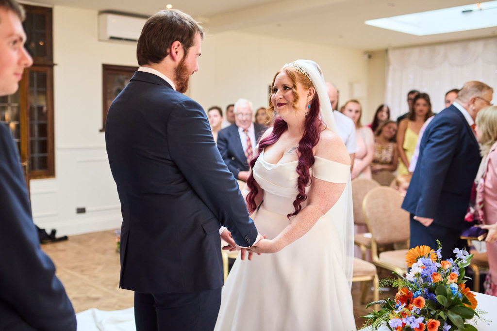 Bride smiling at the groom at the start of the wedding ceremony