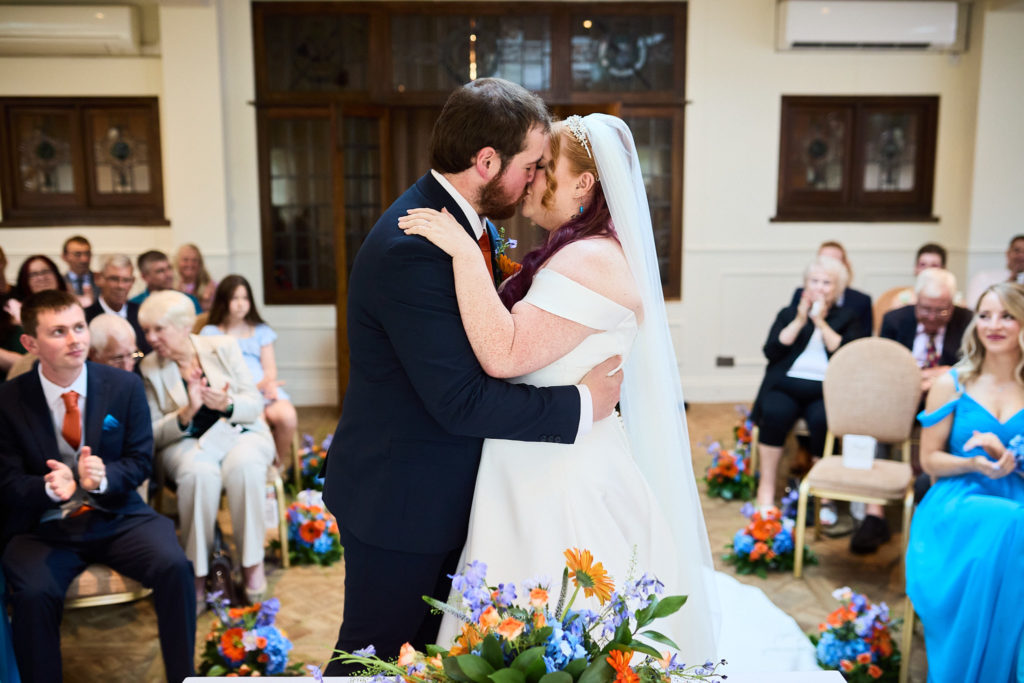 Bride and groom's first kiss in front of their guests