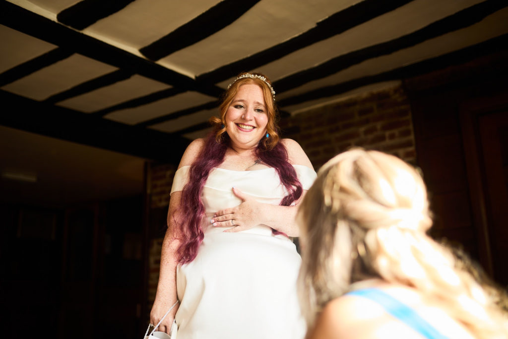 Bride laughing in an oak-beamed room