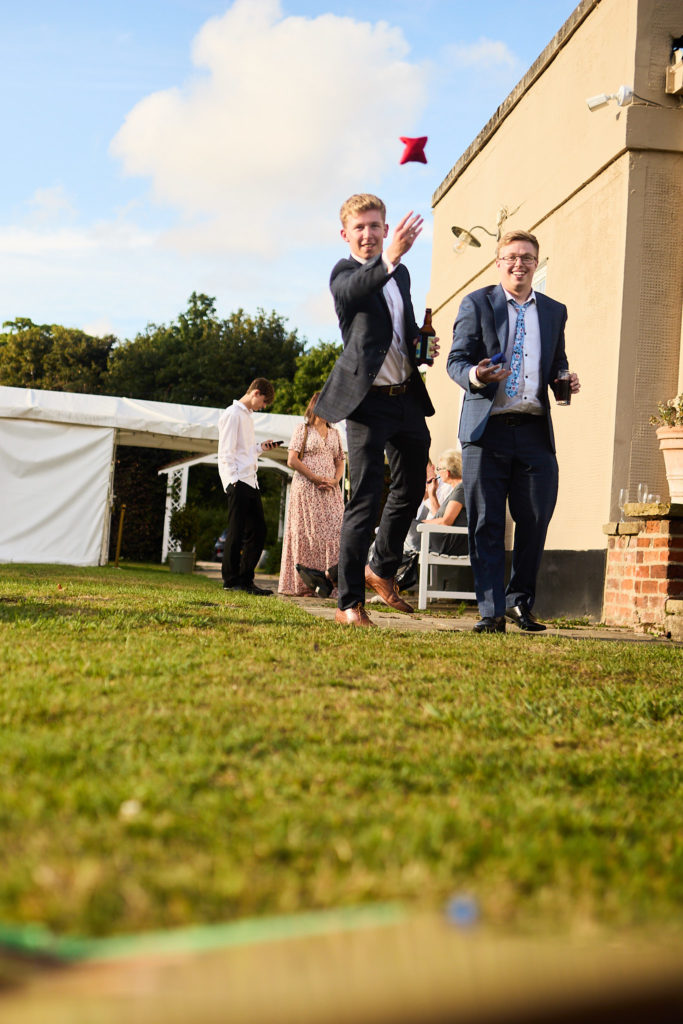 Wedding guests playing lawn games outside Prested Hall