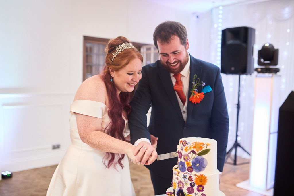 Bride and groom cutting their wedding cake