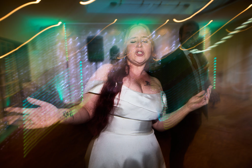 Bride dancing among streaks of coloured light
