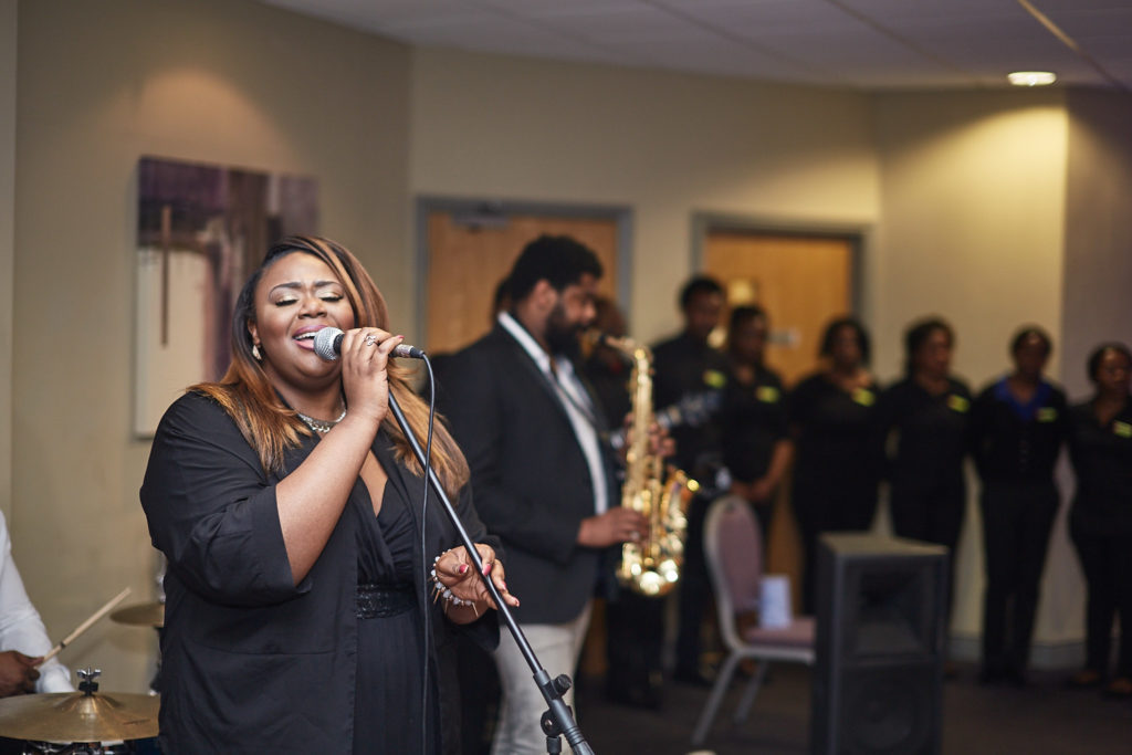 Singer performing with a microphone at the wedding reception