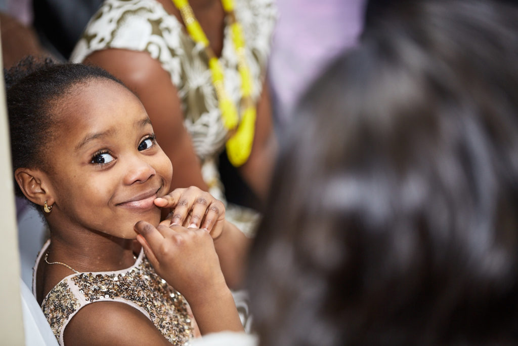 Young girl smiling over her shoulder at the reception