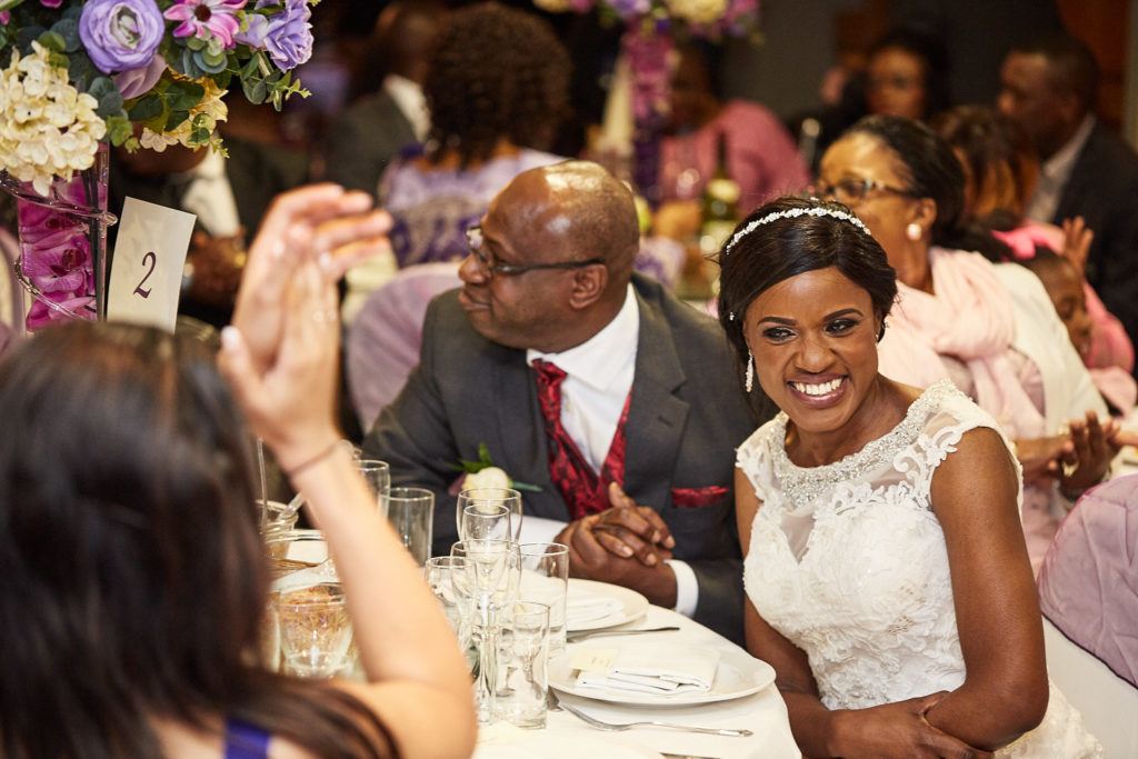 Bride and groom laughing at their table during the wedding breakfast