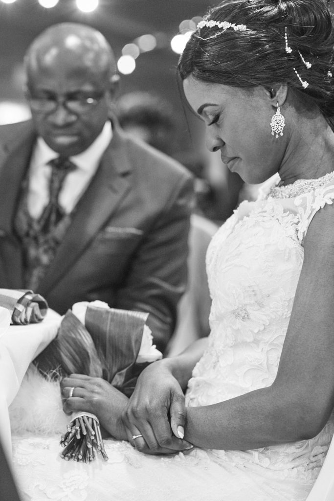 Black and white photo of the bride and groom cutting their wedding cake