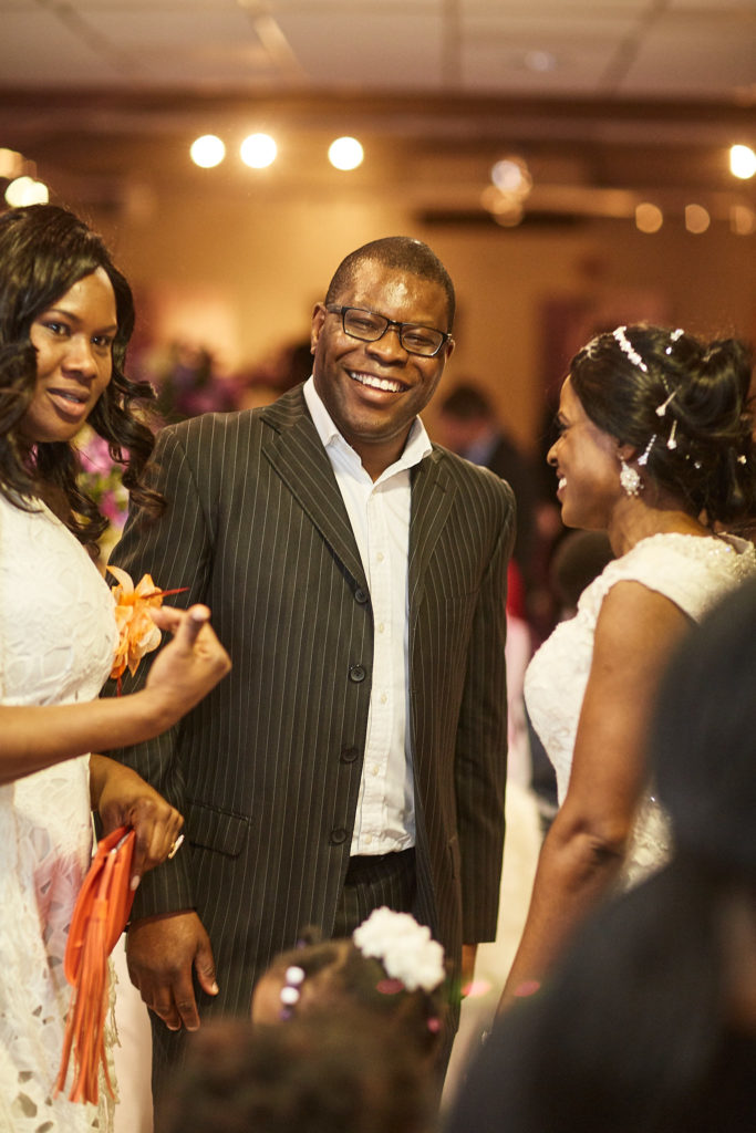 Wedding guests smiling together at the evening reception