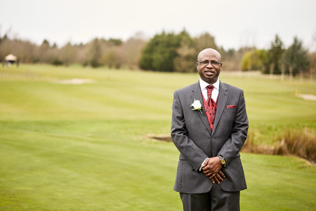 Groom standing on the golf course at Essex Golf Club