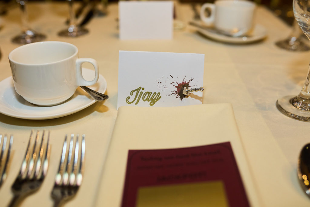 Place setting with a name card and burgundy menu