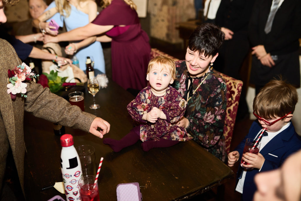 Family with a toddler at a table during the reception