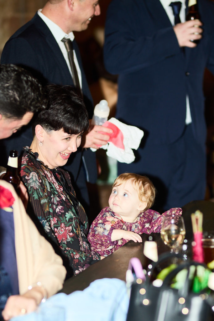 Woman holding a toddler at the table