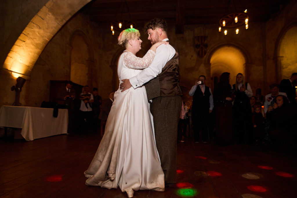 Bride and groom's first dance in the hall at Hedingham Castle