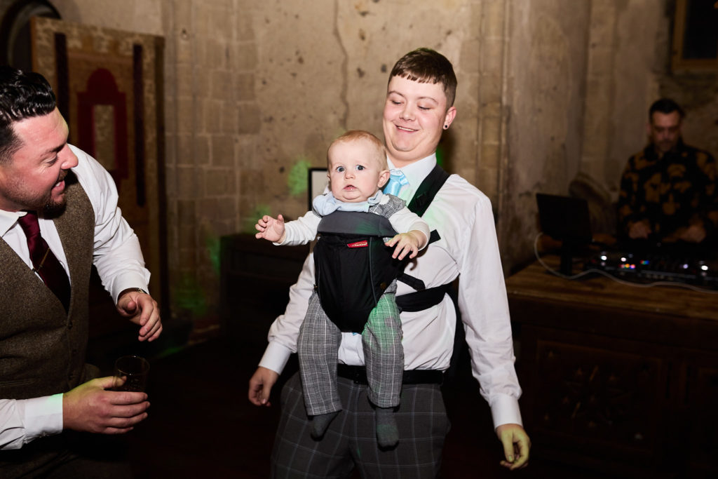 Man dancing with a baby in a carrier