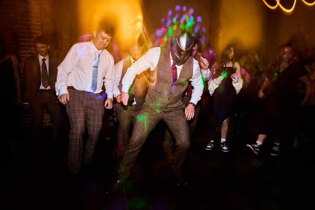 Wedding guests dancing among streaks of light