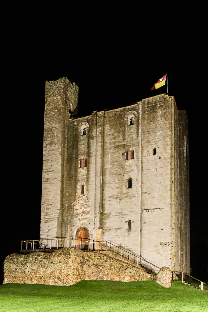 Hedingham Castle keep lit up against the night sky