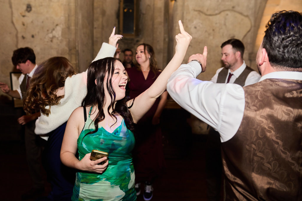 Wedding guests dancing with their hands in the air