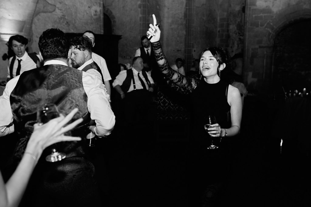 Black and white photo of wedding guests dancing