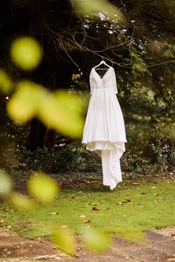 Wedding dress hanging from a tree in the garden