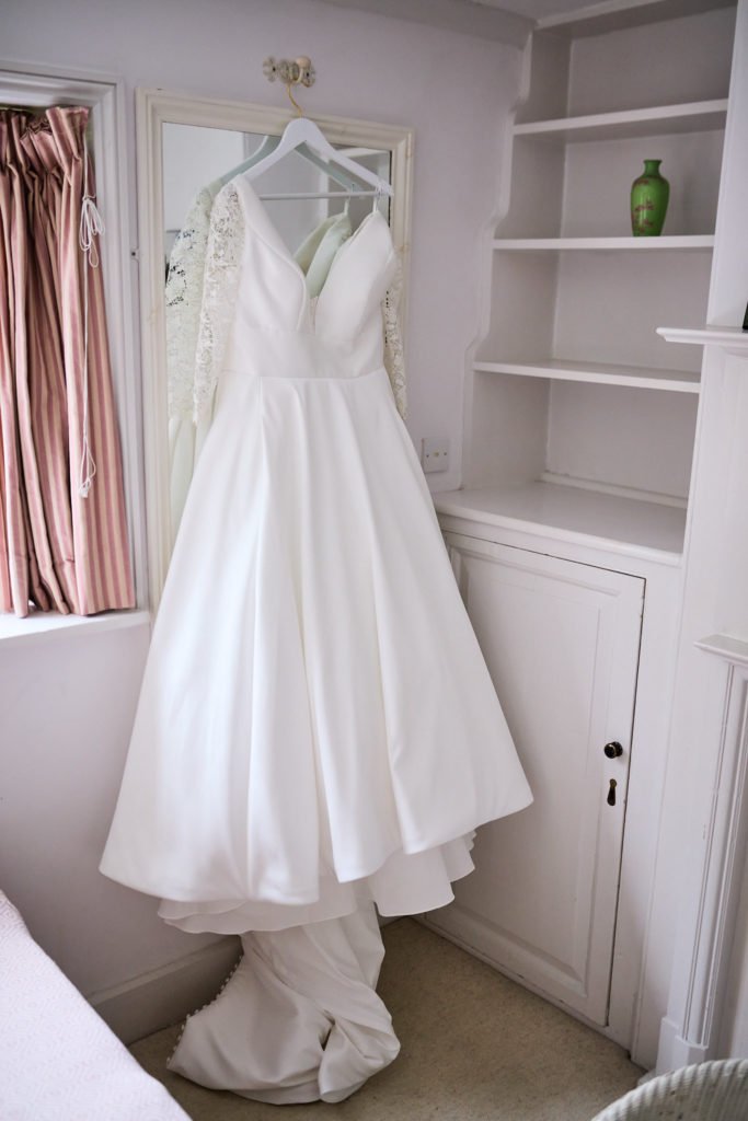 Wedding dress hanging on white shelving