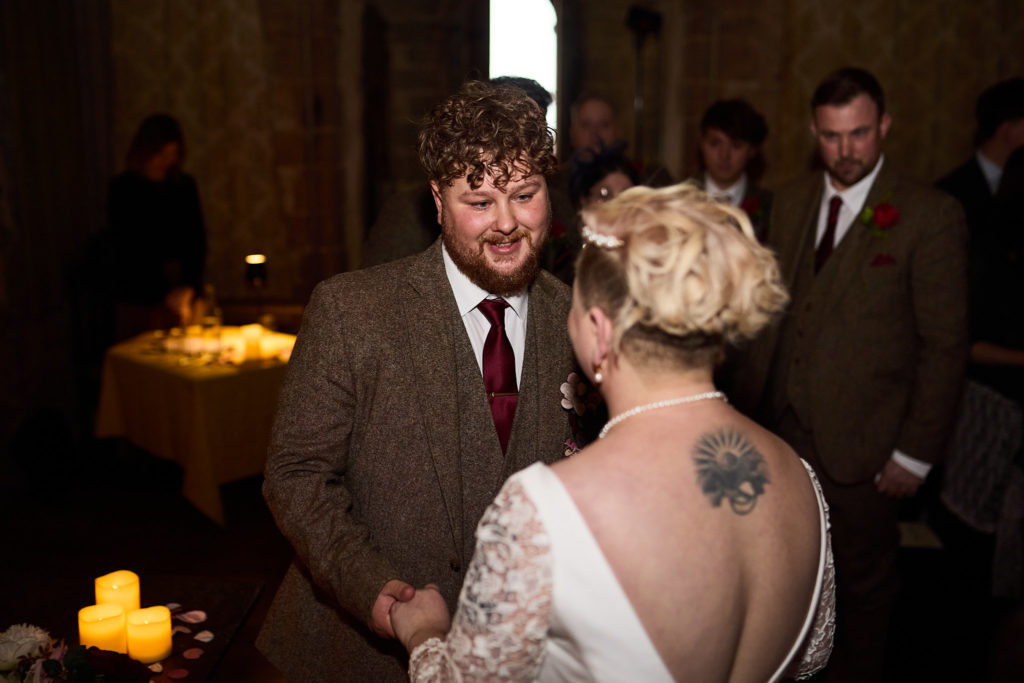 Groom smiling as the bride arrives beside him for the ceremony