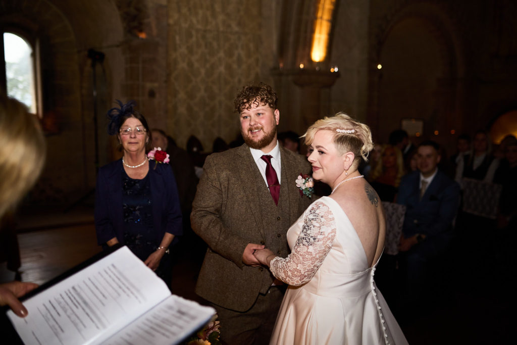 Bride and groom holding hands during their vows