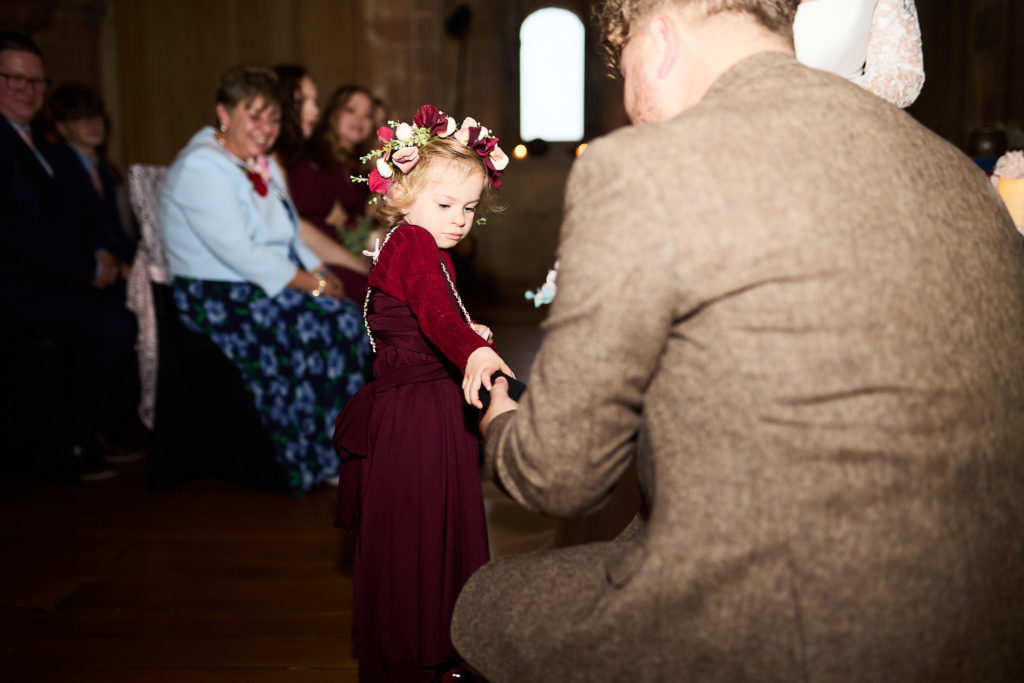 Flower girl bringing the rings to the groom