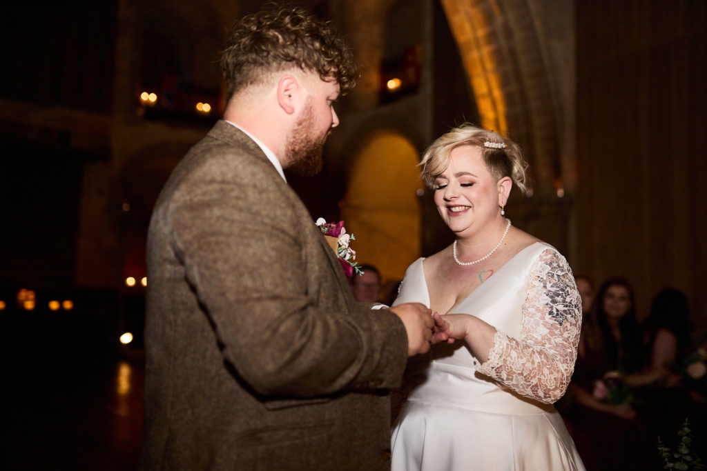 Groom placing the wedding ring on the bride's finger