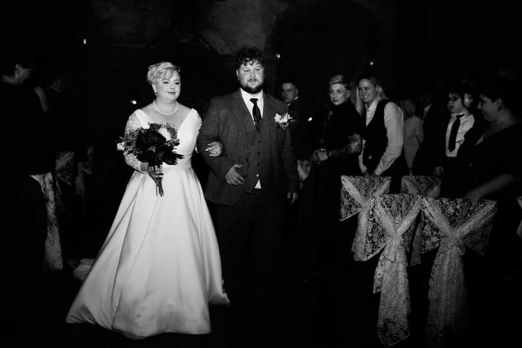 Black and white photo of the bride and groom walking back down the aisle