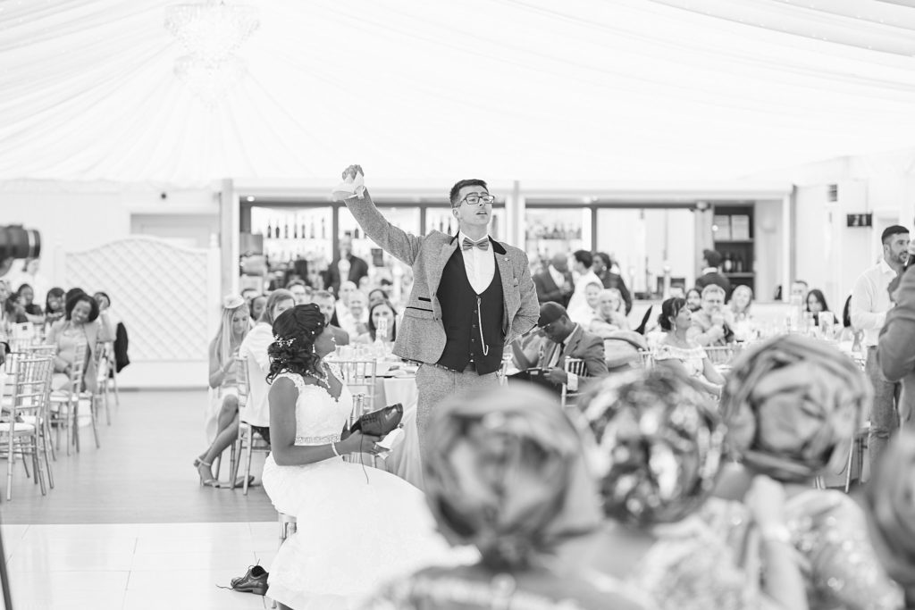 Black and white wide view of the wedding reception in the pavilion at Quendon Hall