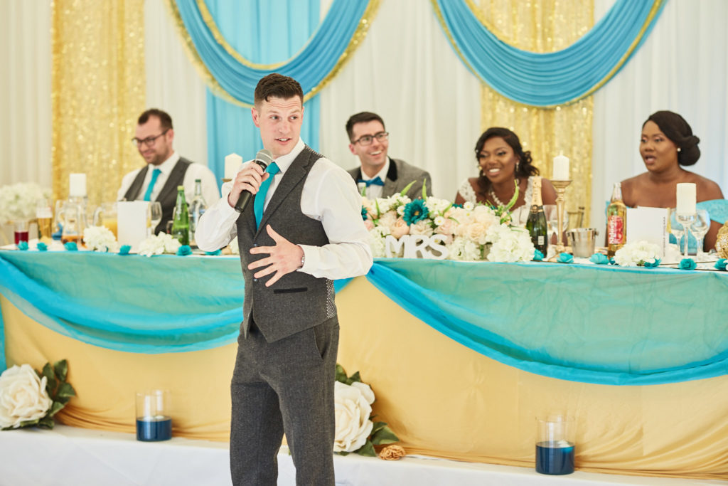 Best man giving his speech in front of the top table