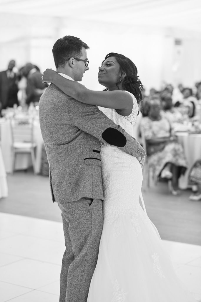 Black and white photo of the bride and groom's first dance at Quendon Hall