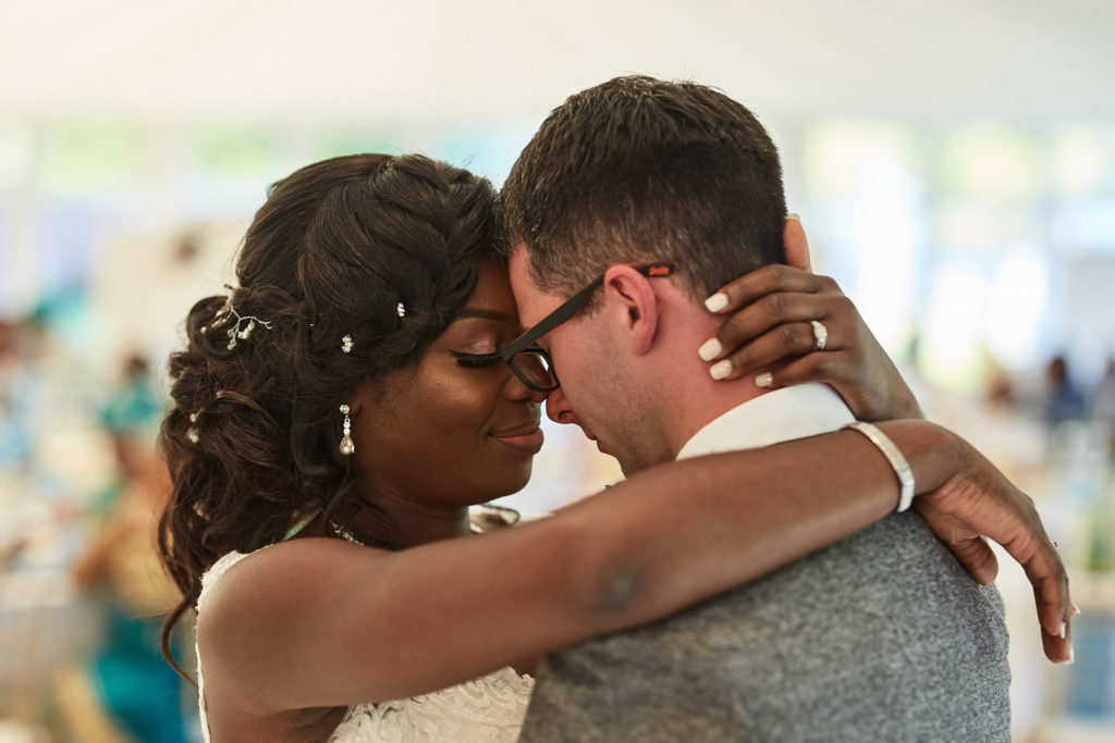 Close-up of the bride and groom forehead to forehead during their first dance