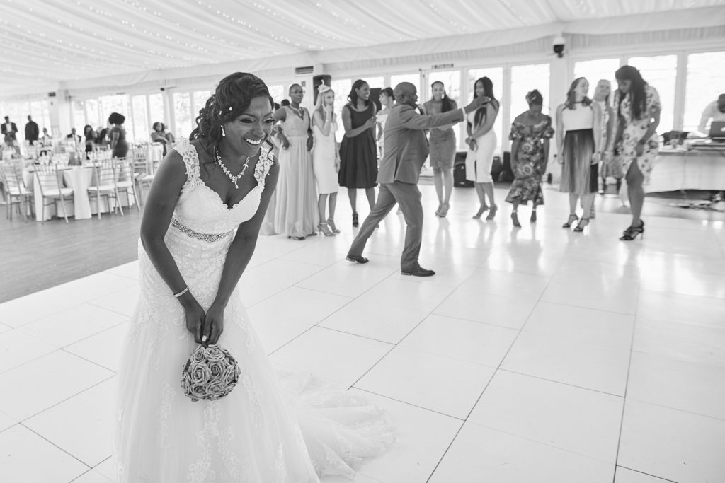 Black and white photo of the bride getting ready to throw her bouquet