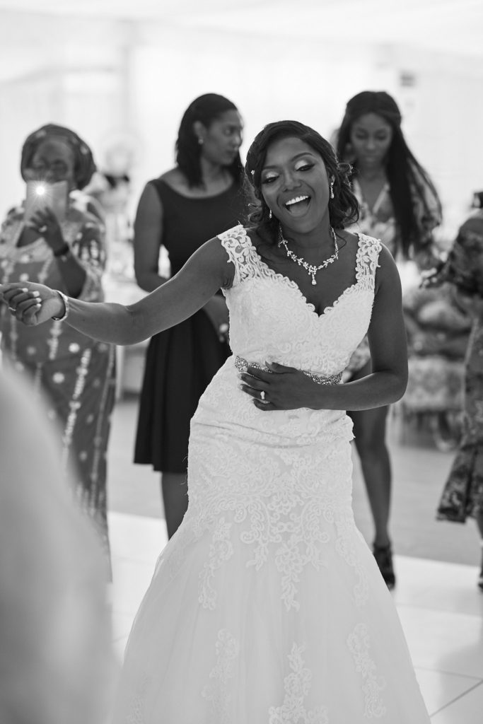 Black and white photo of the bride dancing with her guests
