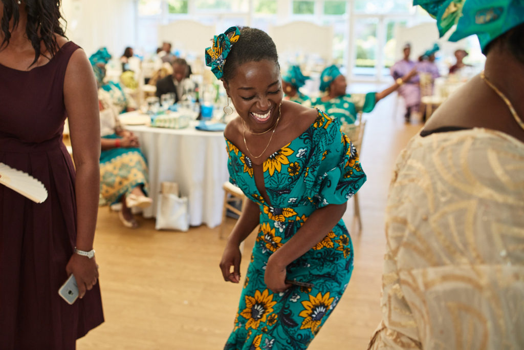 Guest in a turquoise print dress dancing