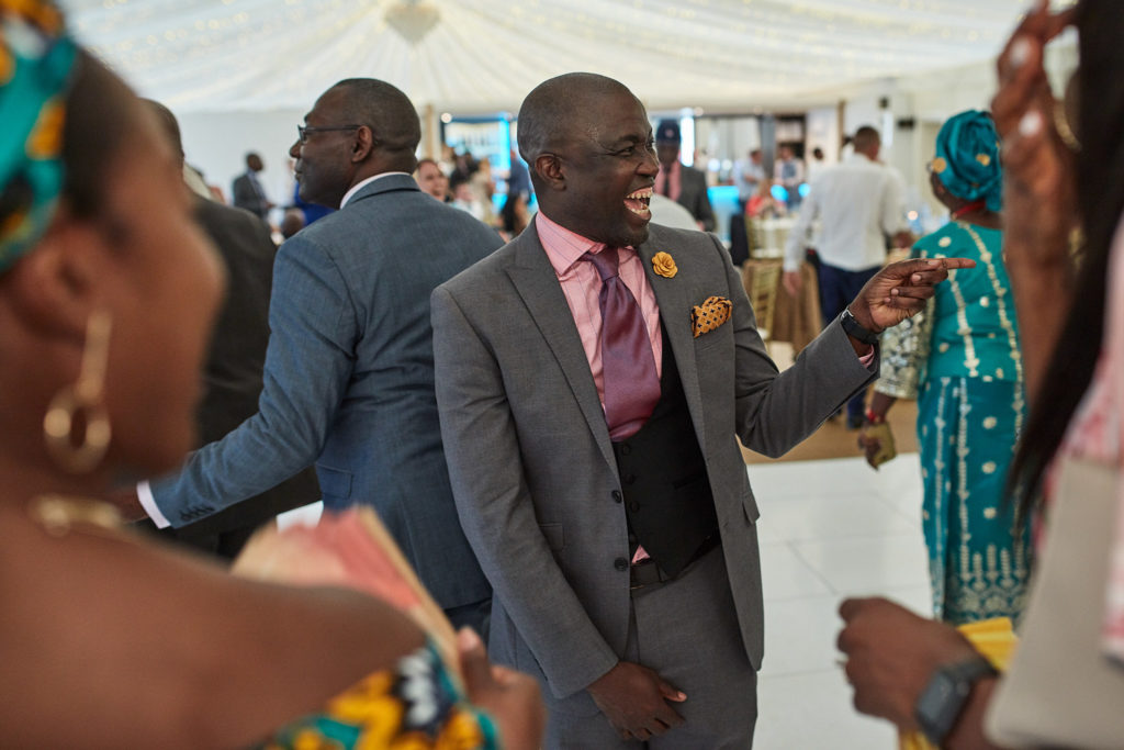 Wedding guests dancing and laughing in the pavilion