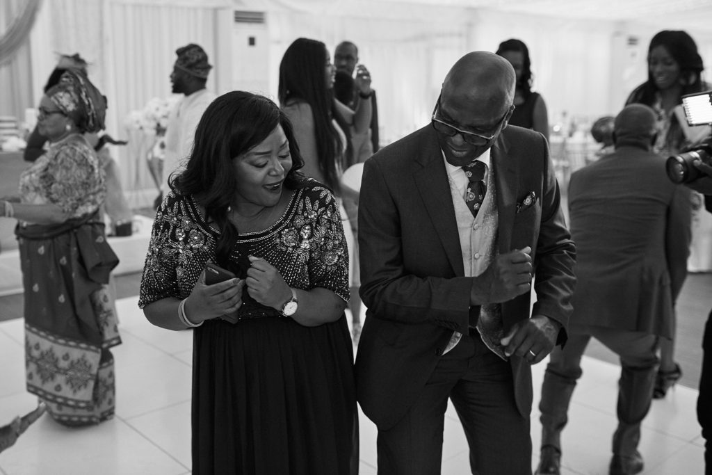Black and white photo of guests dancing at the reception