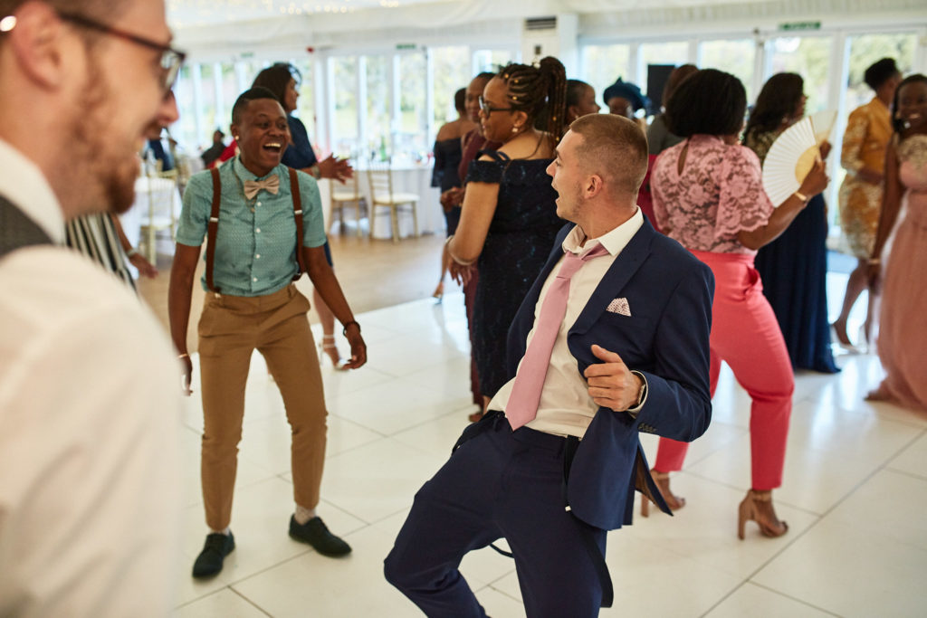 Wedding guests dancing on the white dance floor
