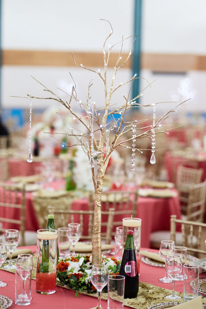 Crystal tree centrepiece on a table dressed in red at a traditional Itsekiri wedding