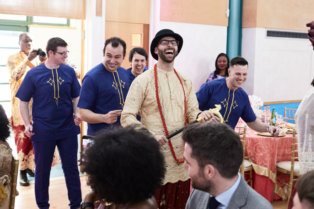 Groom arriving with his groomsmen in matching blue tunics
